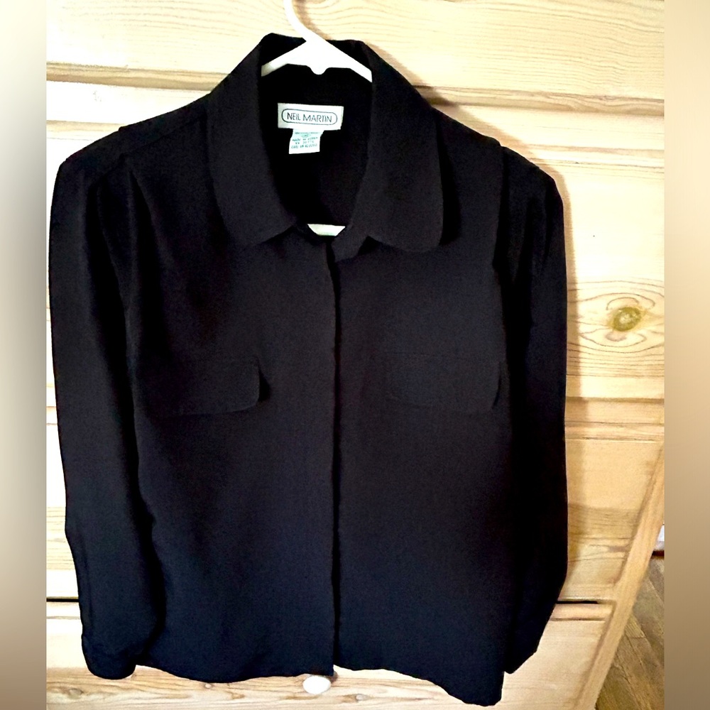 Double breasted black silky shirt.